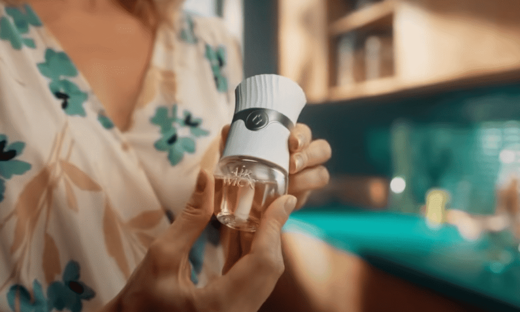 Woman holding an airwick air freshner