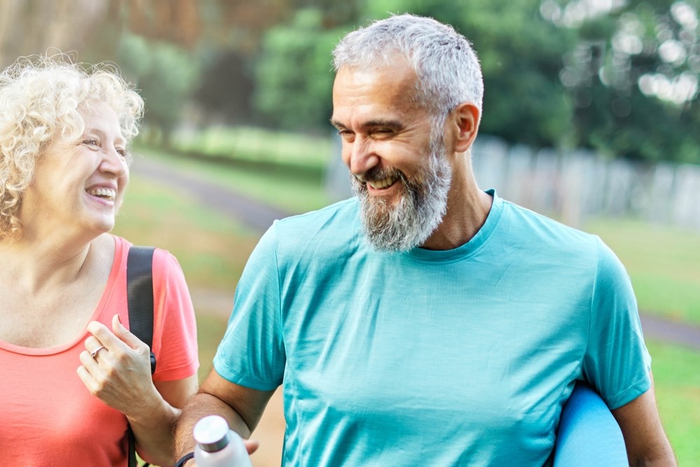 middle aged couple exercising chatting