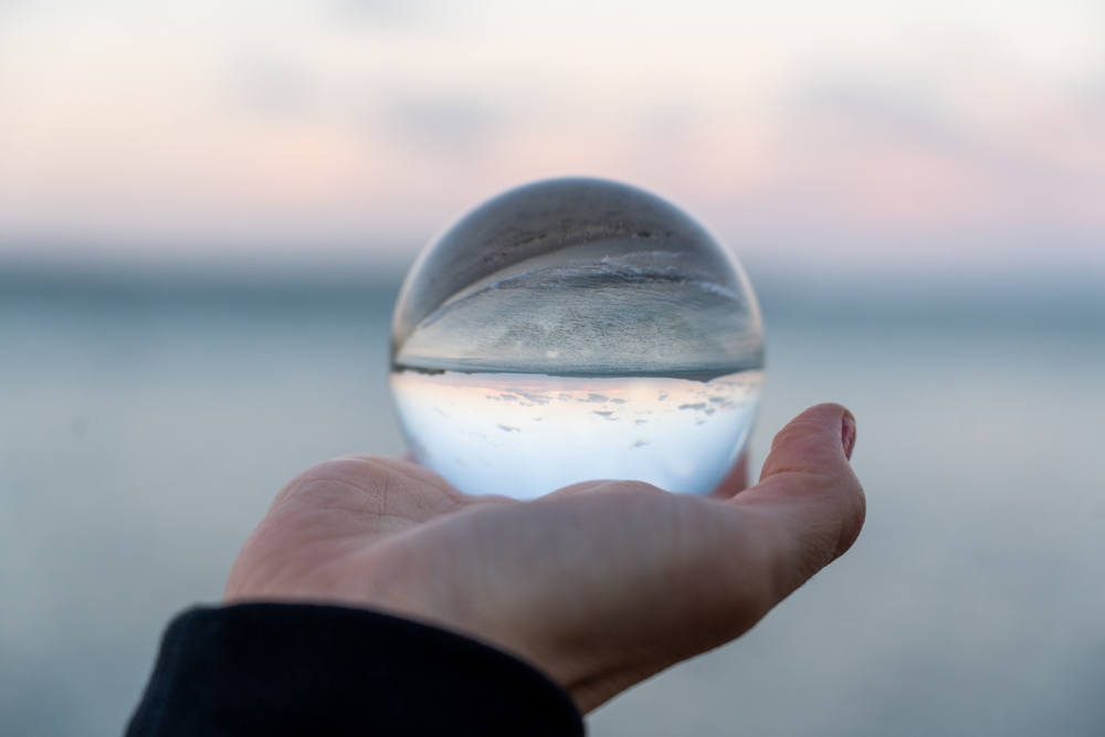 Hand,Holding,A,Glass,Ball,Reflecting,The,Ocean,At,Kohimarama, Nucleus AI Hub